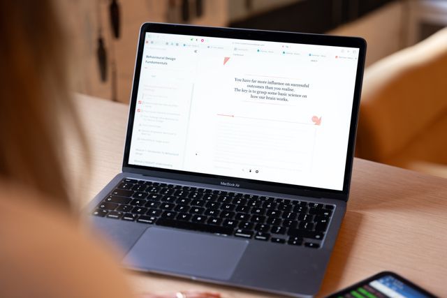Laptop showing SUE’s online learning environment on a wooden table