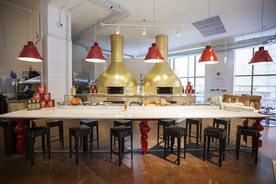 Inside Eataly Chicago, showing the open market layout with food stalls and an animated crowd