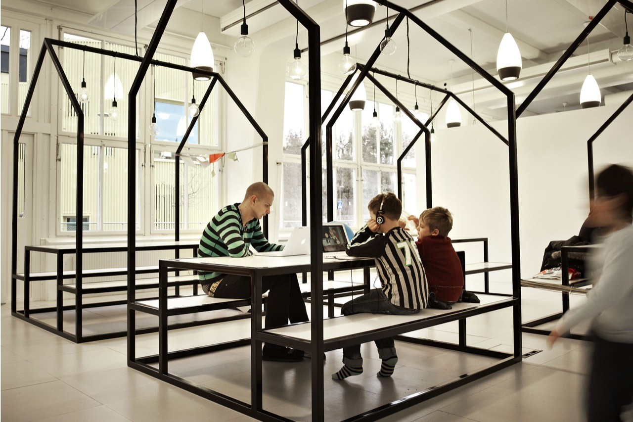 Black steel house-frame workspace pods at Vittra Telefonplan, creating defined zones within the open school