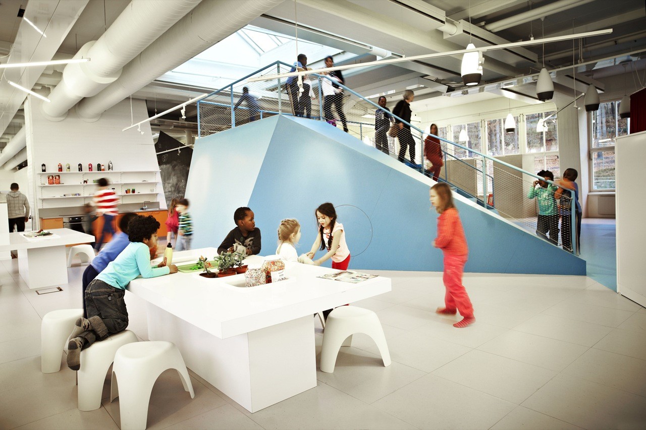 Children learning in the open landscape of Vittra Telefonplan school in Stockholm, designed by Rosan Bosch