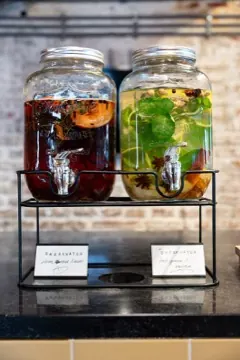 Two glass dispensers of infused water on the bar