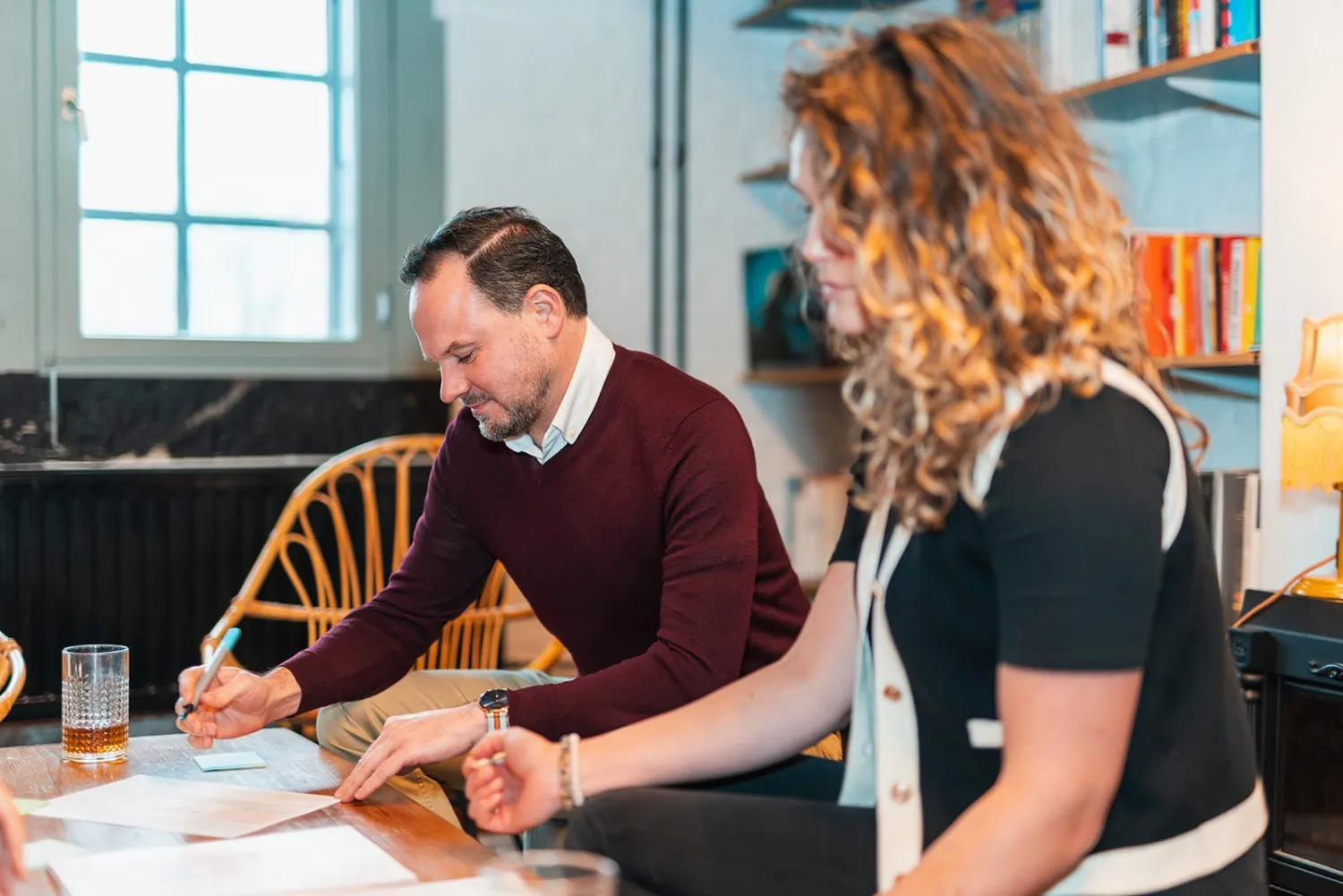 Two participants working out a message together on paper during the course