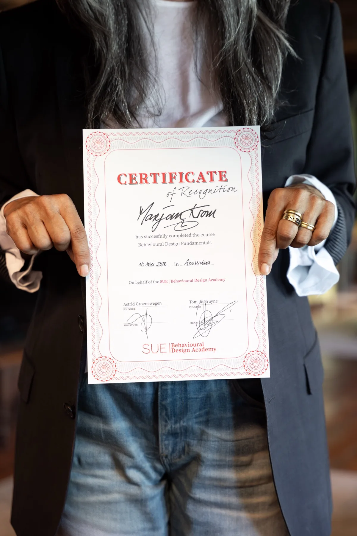 Participant showing her certificate after the training in Amsterdam