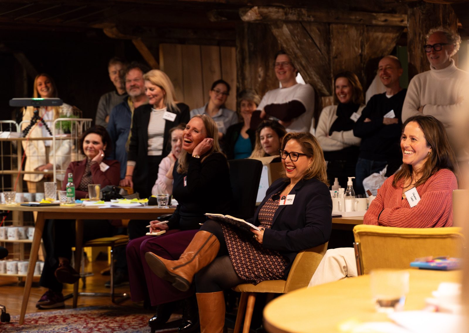 A full room of participants laughing during a SUE training in Amsterdam